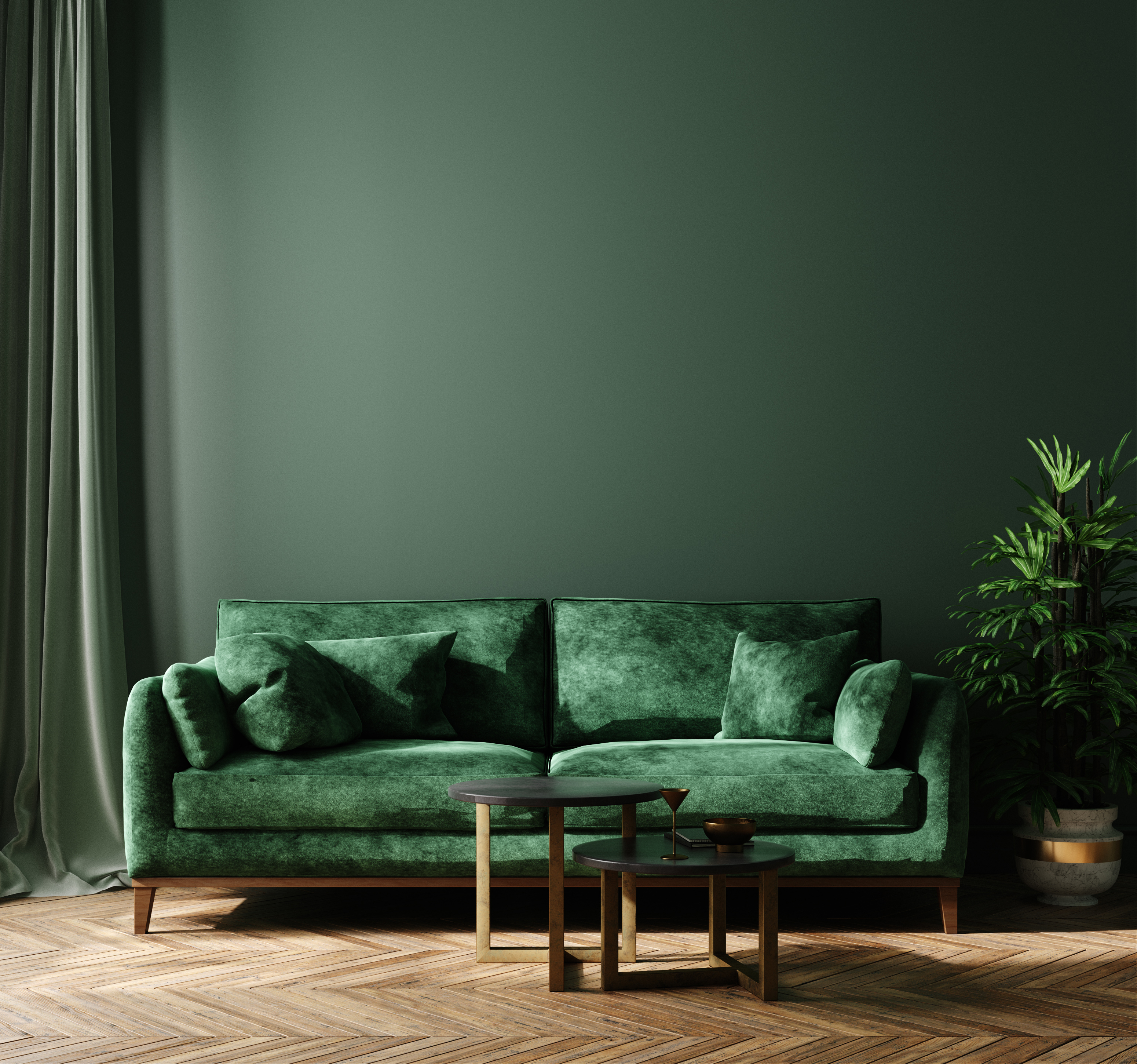 green velvet sofa in front of forest green wall