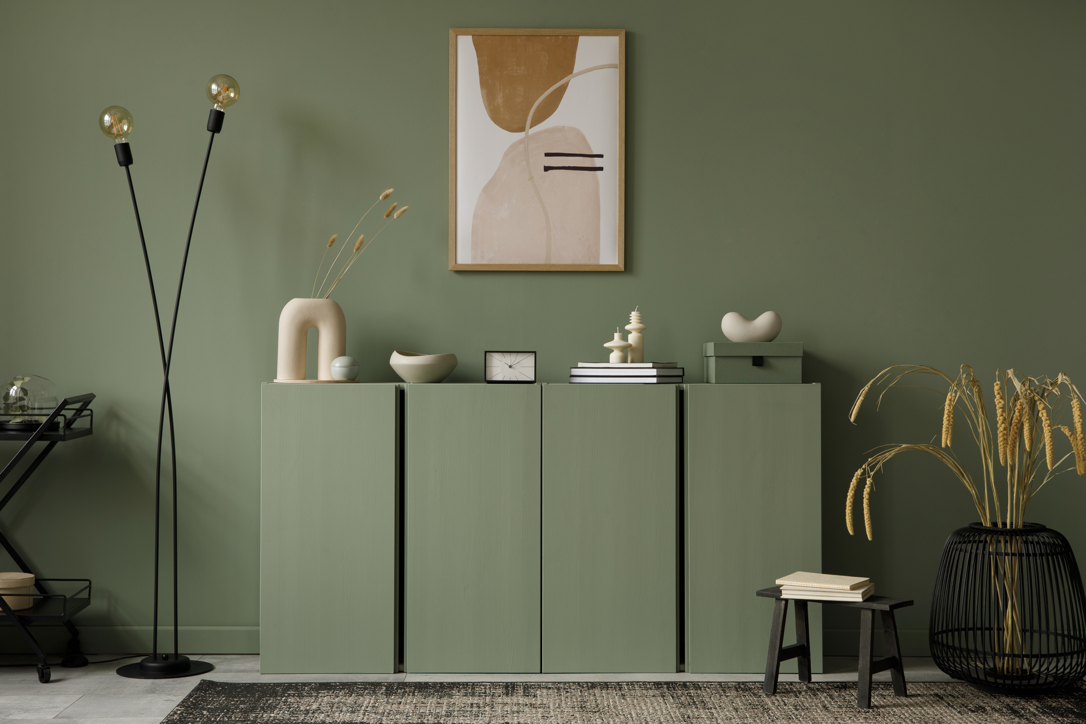 painted green room with beige and black accessories