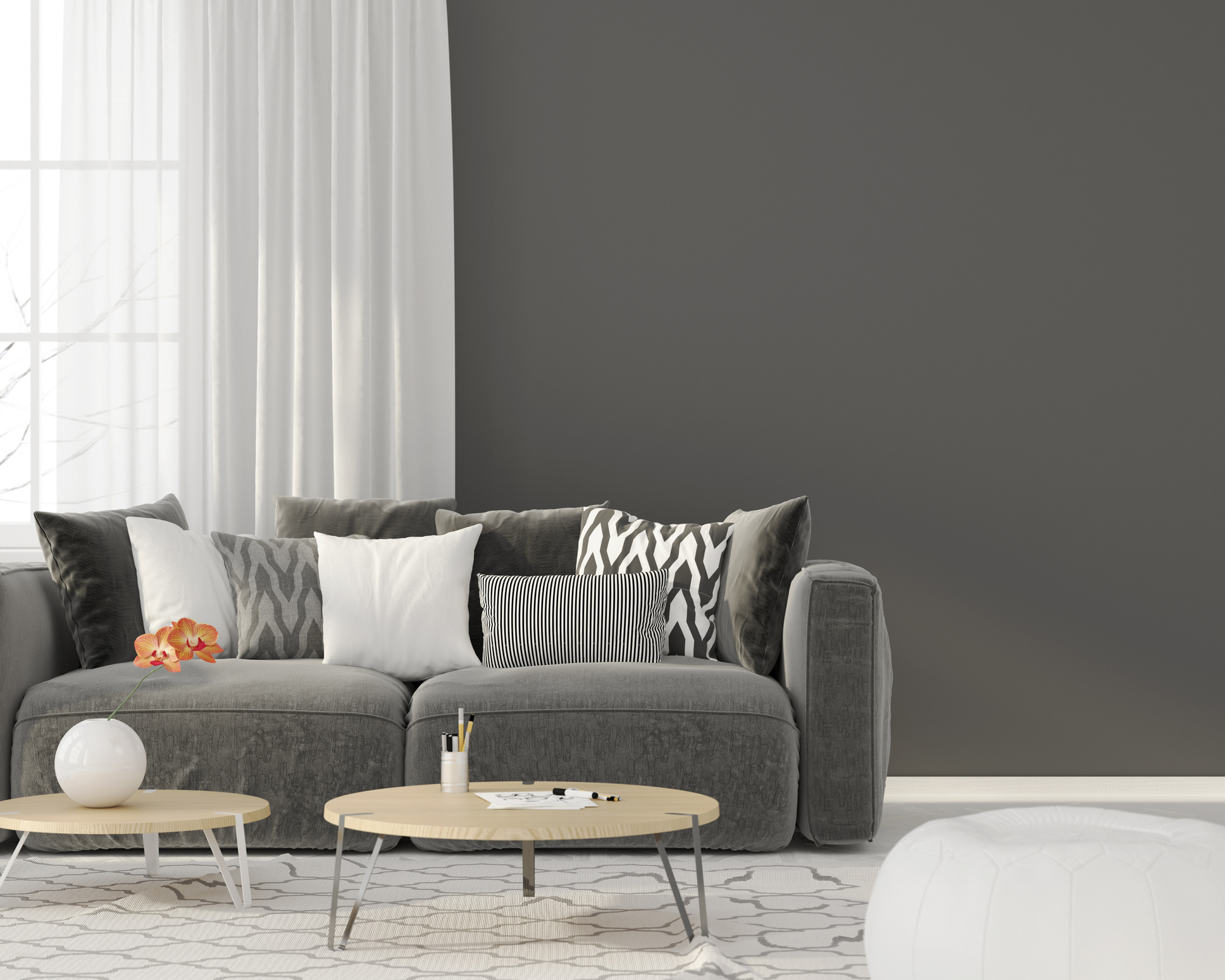 lounge with sofa in front of feature black/dark grey wall